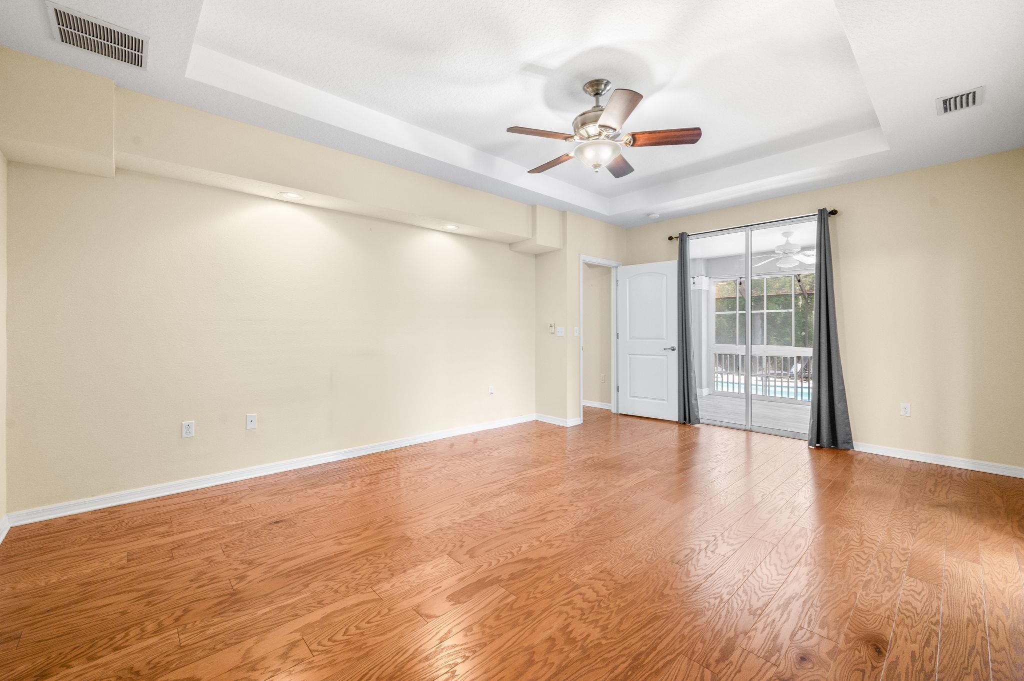 1184 Overdale Road St. Augustine, FL 32080 - Photo 53 of 75 Unfurnished room with a ceiling fan, light wood-type flooring, and a tray ceiling