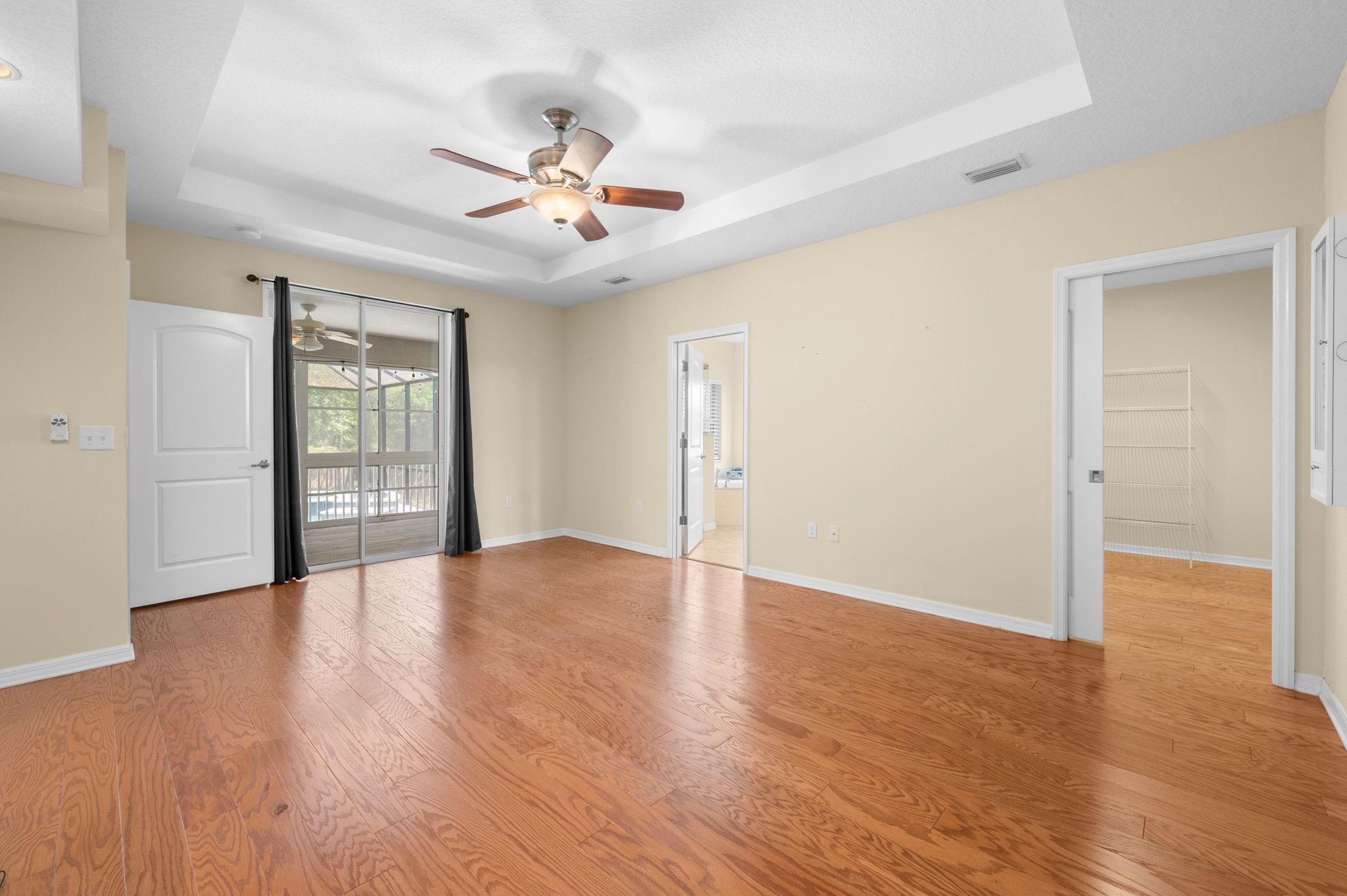 1184 Overdale Road St. Augustine, FL 32080 - Photo 54 of 75 Spare room featuring a ceiling fan, a tray ceiling, and light wood-style flooring