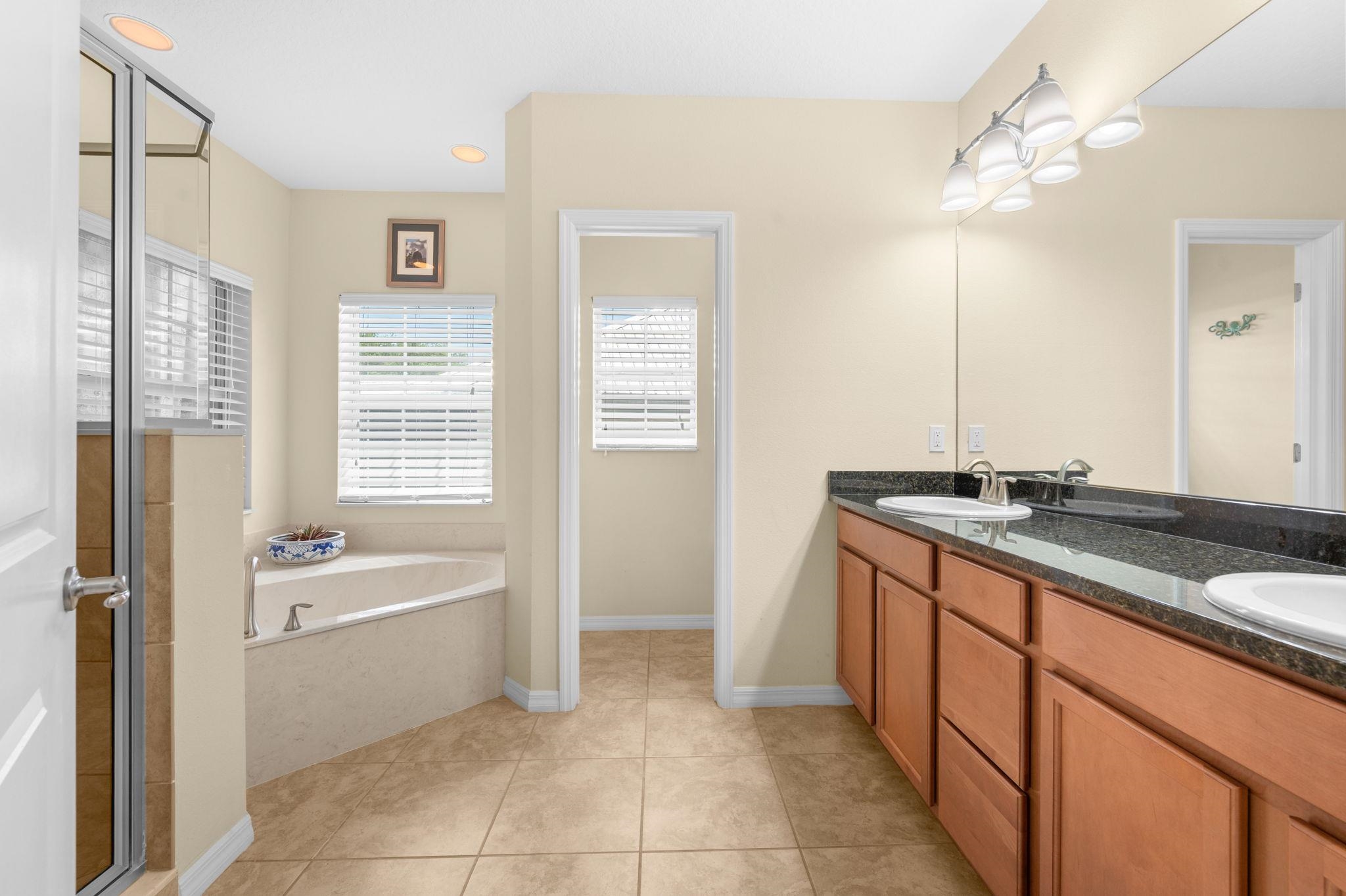 1184 Overdale Road St. Augustine, FL 32080 - Photo 55 of 75 Full bath featuring double vanity, a shower stall, light tile patterned flooring, and a garden tub