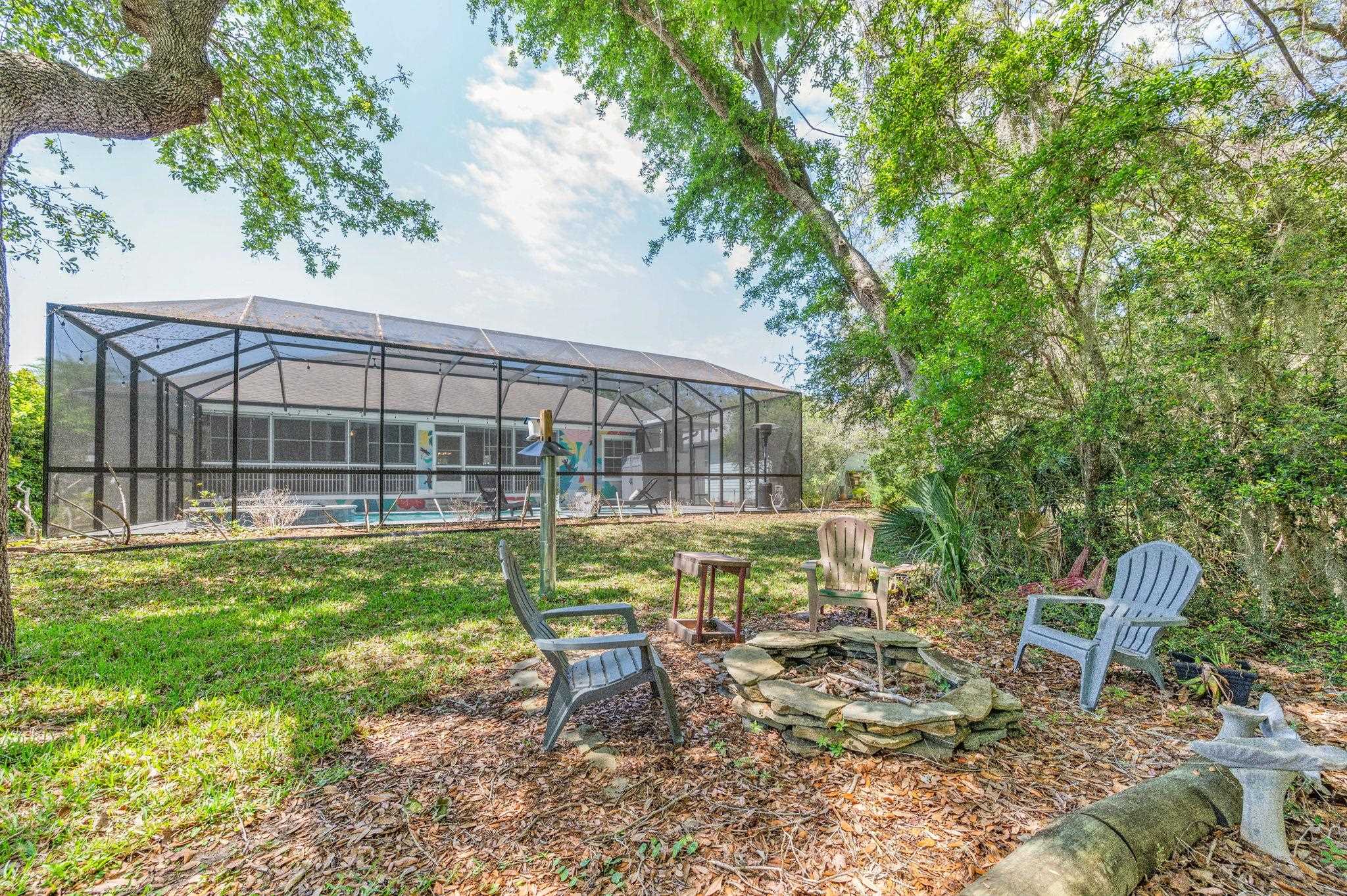 1184 Overdale Road St. Augustine, FL 32080 - Photo 68 of 75 View of yard with a sunroom, a pool, a fire pit, glass enclosure, and a patio