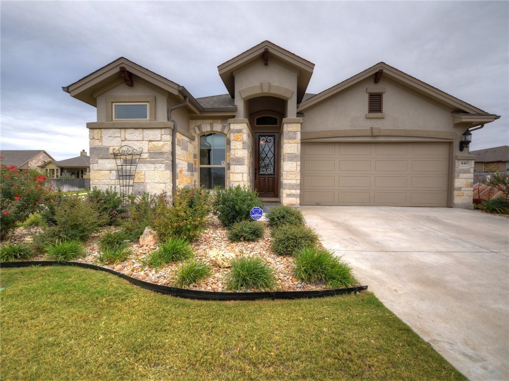 a front view of a house with a yard and garage