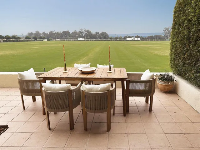 a view of an outside dining space with furniture