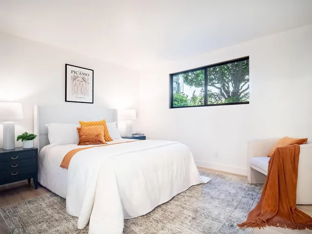 a bedroom with a bed and a couch