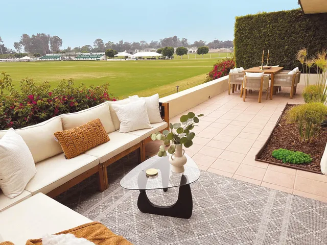 a view of a lake with couches and city view