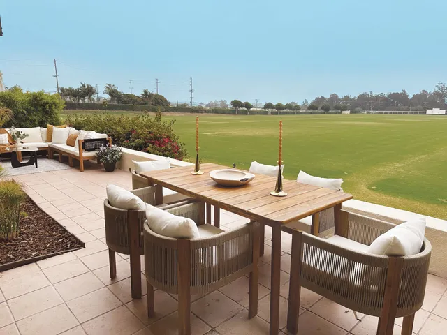 a view of a terrace with couches and city view