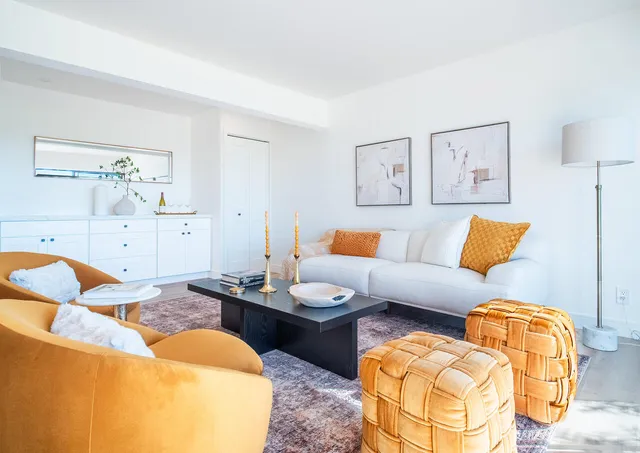 a living room with furniture and painting on the wall