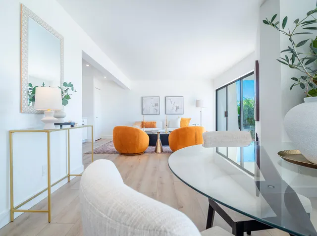 a living room with furniture and wooden floor