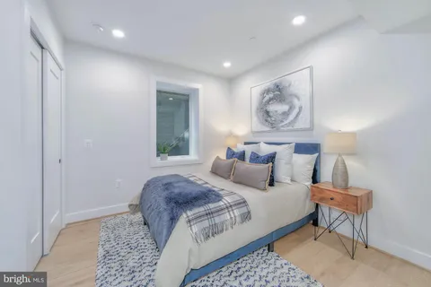 a bedroom with bed and night stand