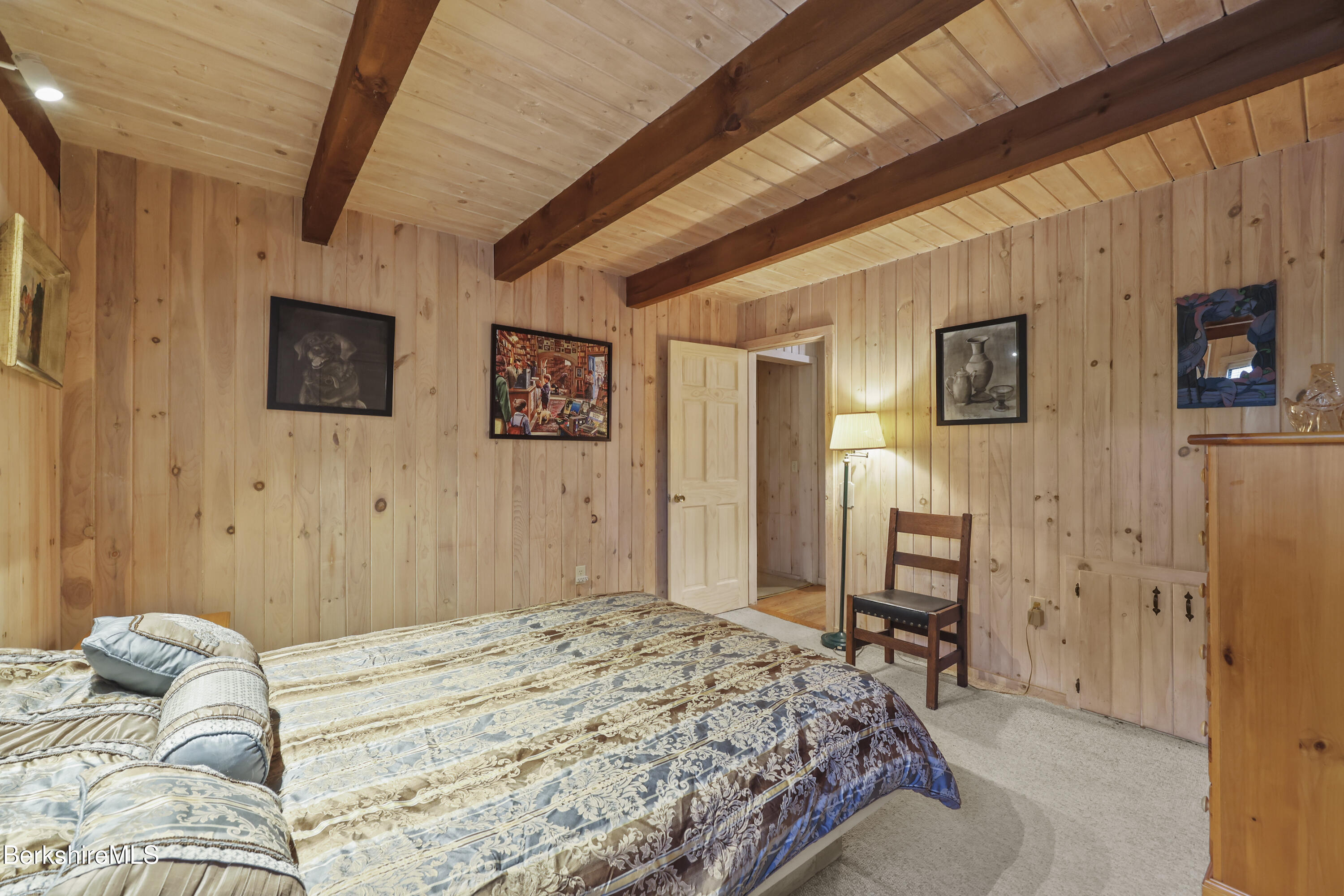 422 Bonny Rigg Hill Road Becket, MA 01223 - Photo 24 of 60 a bedroom with a bed dresser and a flat tv screen