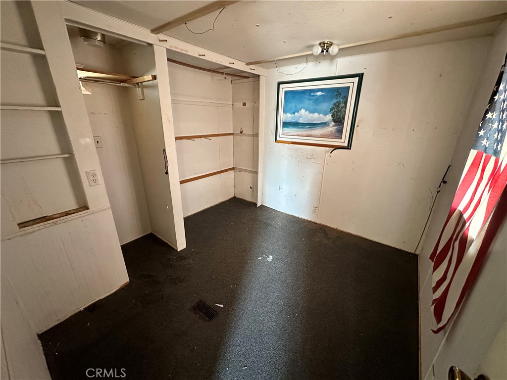 1609 Riviera Drive Blythe, CA 92225 - Photo 20 of 40 an empty room with wooden floor and a window