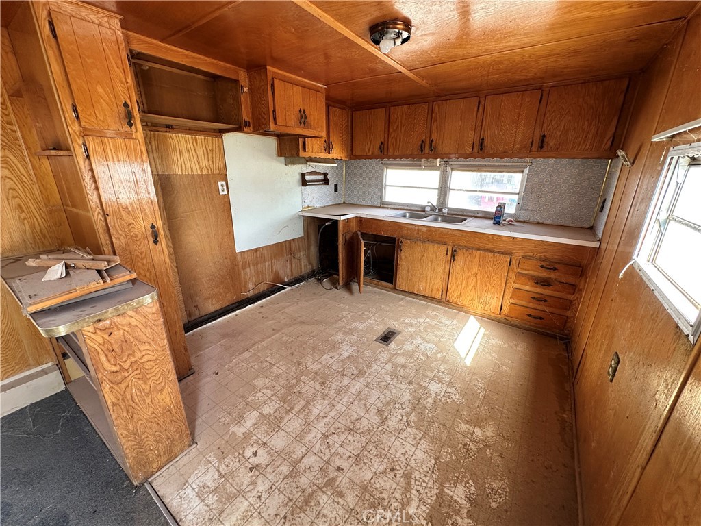 1609 Riviera Drive Blythe, CA 92225 - Photo 31 of 40 a kitchen with stainless steel appliances kitchen island granite countertop a refrigerator and a stove top oven