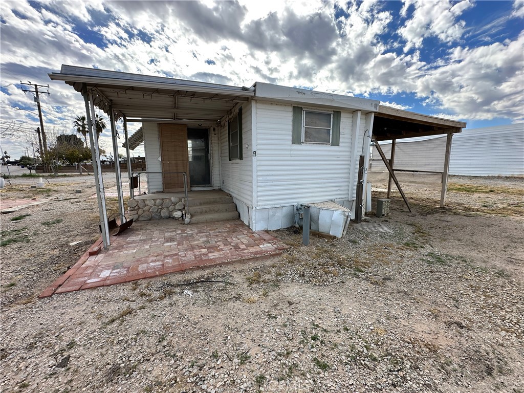 1609 Riviera Drive Blythe, CA 92225 - Photo 9 of 40 a view of a house with a porch and furniture