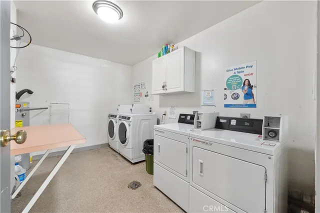 a utility room with cabinets washer and dryer
