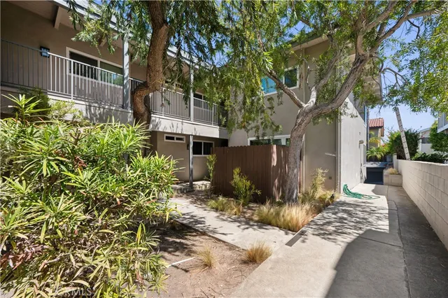 a view of a house with a yard and tree s