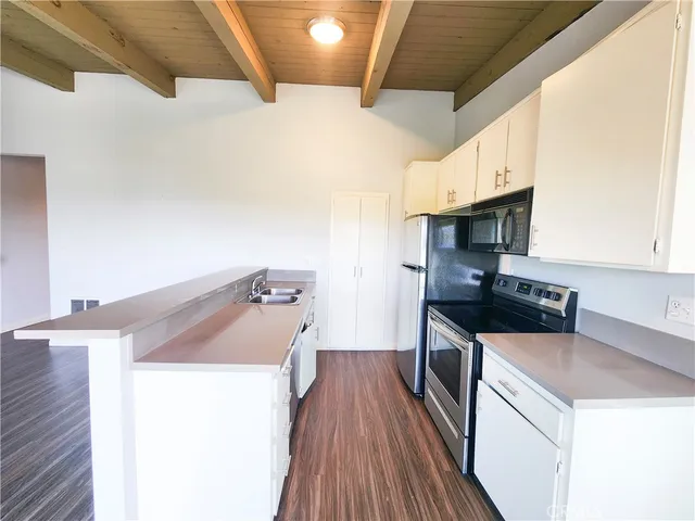 a kitchen that has a sink and a stove top oven