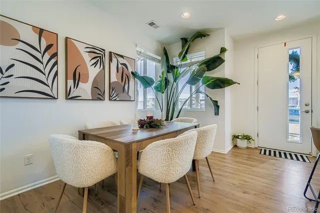 a dining room with furniture and wooden floor
