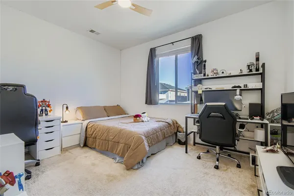 a bedroom with a bed and a chair