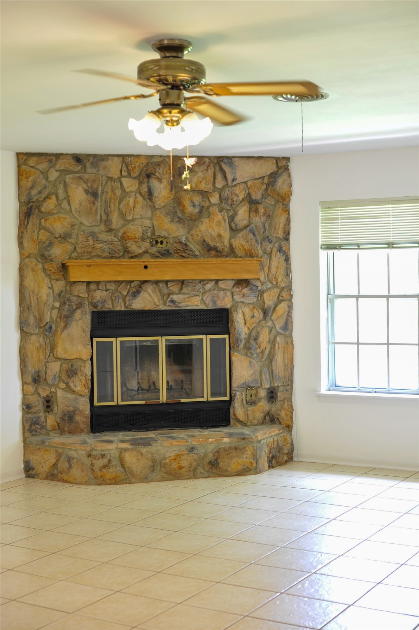 402 Peach Point Road Jones Creek, TX 77541 - Photo 14 of 32 The stone fireplace is the focal point of the living area.