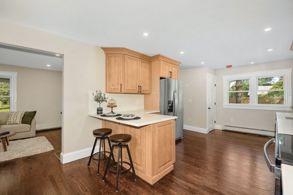 533 Edgell Road Framingham, MA 01701 - Photo 12 of 36 a view of kitchen with stainless steel appliances granite countertop cabinets wooden floor and a window