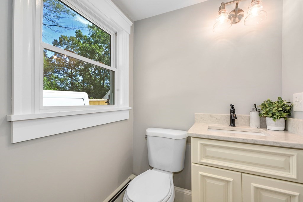 533 Edgell Road Framingham, MA 01701 - Photo 18 of 36 a bathroom with a sink a toilet and a window