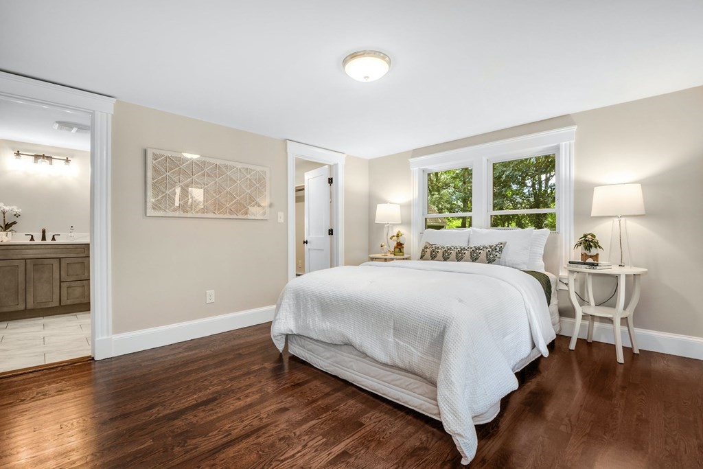 533 Edgell Road Framingham, MA 01701 - Photo 19 of 36 a large bed sitting in a bedroom and a table