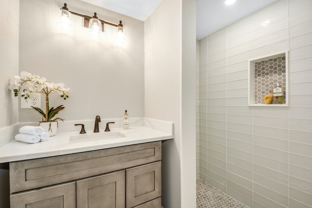 533 Edgell Road Framingham, MA 01701 - Photo 20 of 36 a bathroom with a sink and a mirror