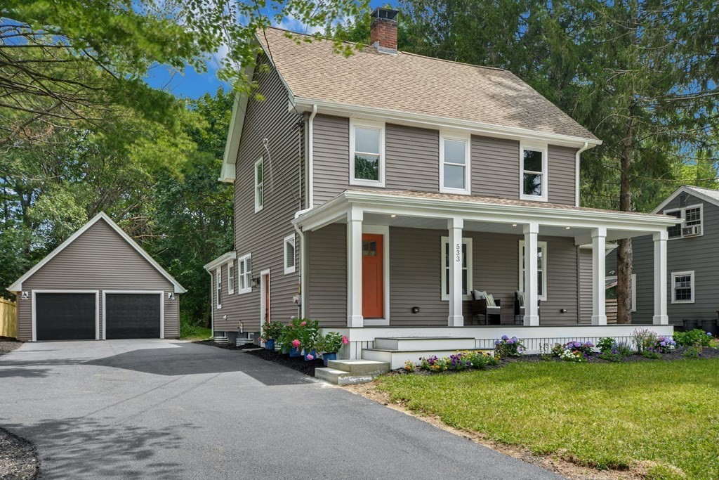 533 Edgell Road Framingham, MA 01701 - Photo 2 of 36 a front view of a house with a yard and garage