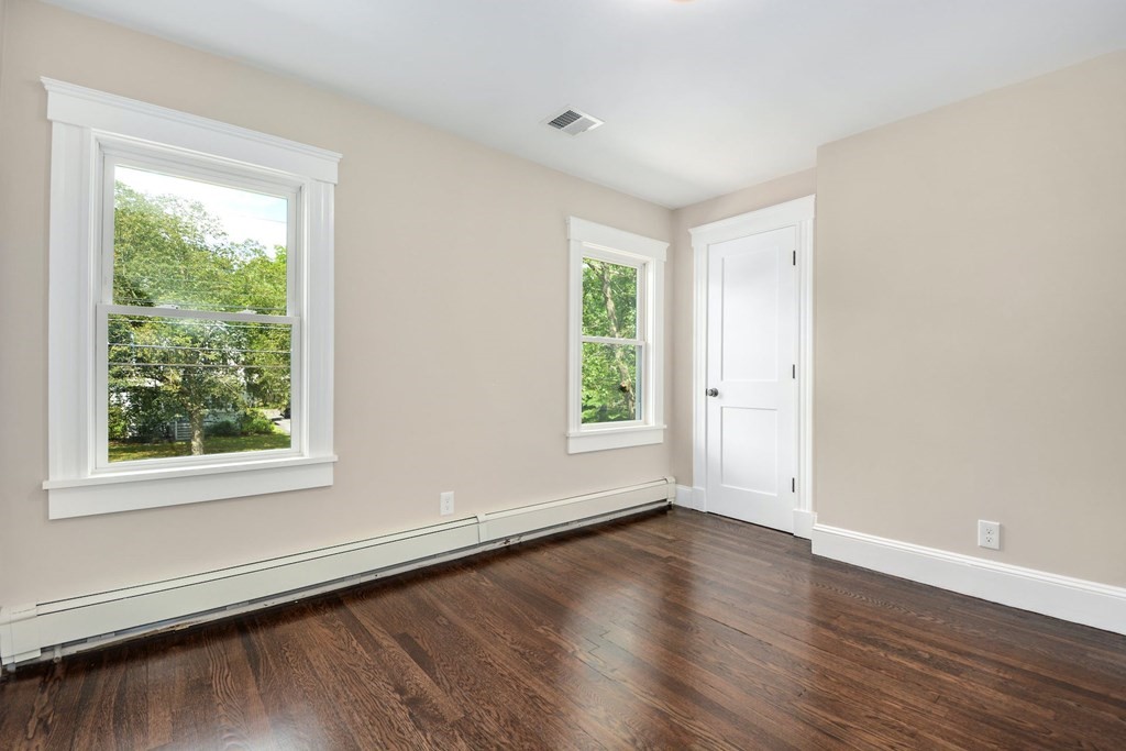 533 Edgell Road Framingham, MA 01701 - Photo 24 of 36 a view of an empty room with wooden floor and a window