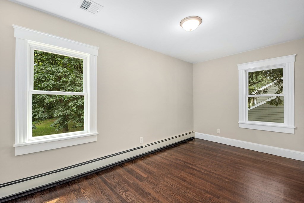 533 Edgell Road Framingham, MA 01701 - Photo 25 of 36 an empty room with wooden floor and windows
