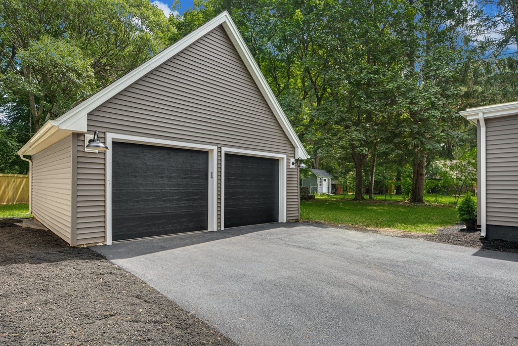 533 Edgell Road Framingham, MA 01701 - Photo 28 of 36 a view of a house with a yard and garage
