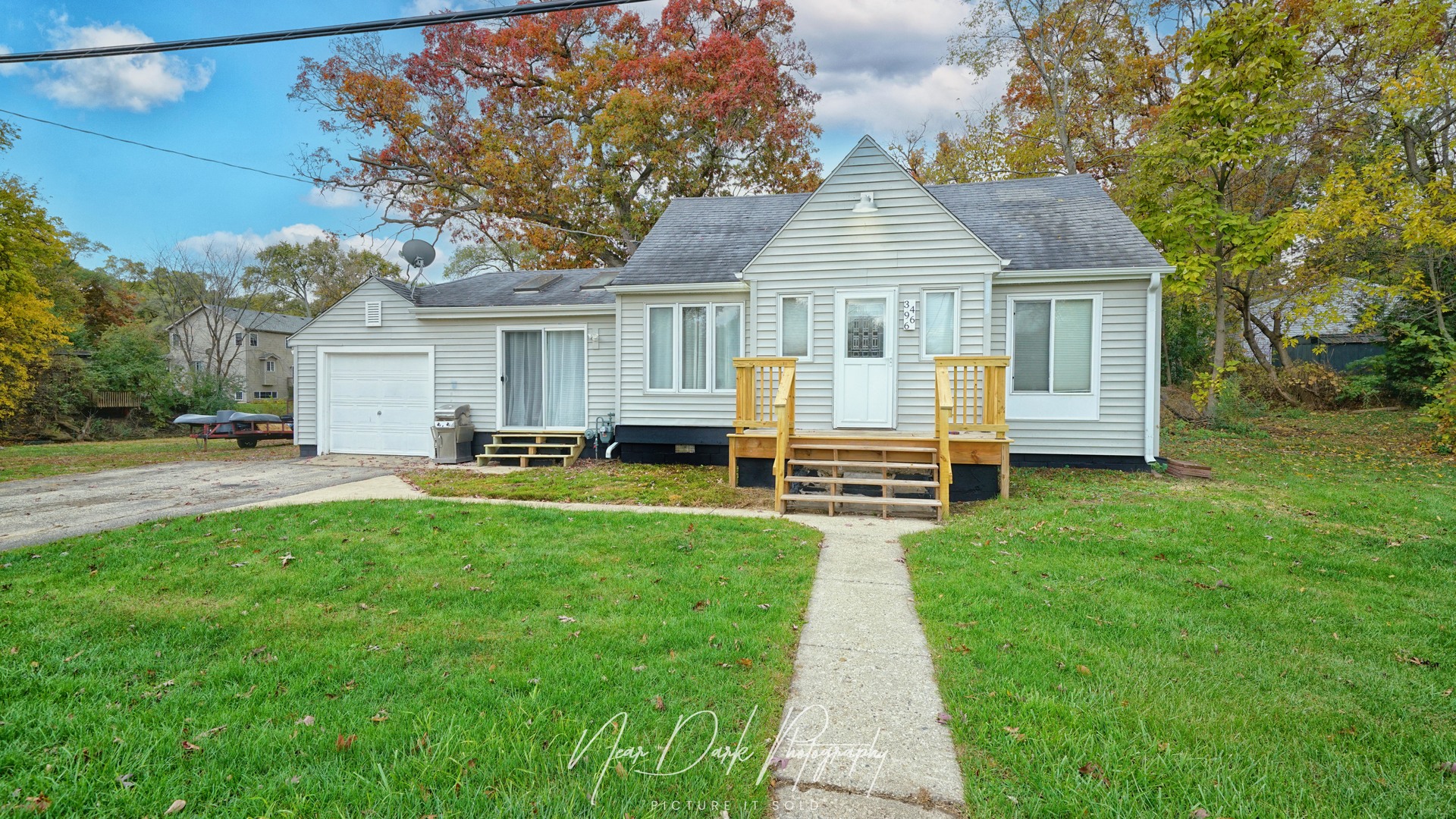 a front view of house with yard and trees