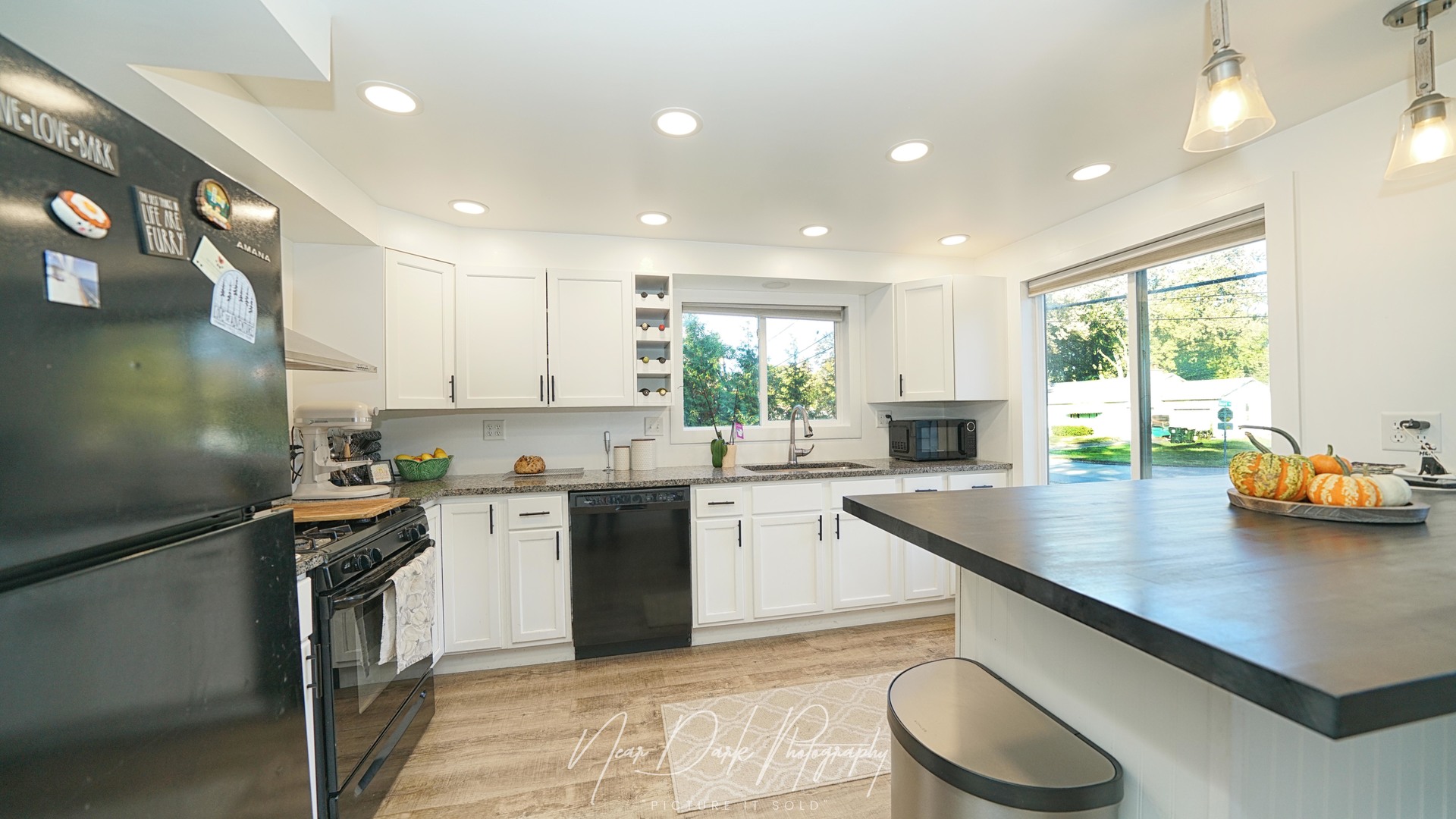 34966 North Forest Avenue Ingleside, IL 60041 - Photo 9 of 46 a kitchen with granite countertop a sink stove and refrigerator