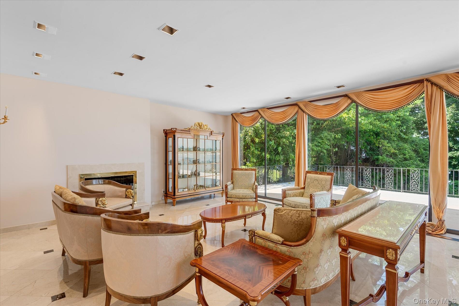 512 East Shore Road Great Neck, NY 11024 - Photo 11 of 46 a living room with furniture a large window and a flat screen tv