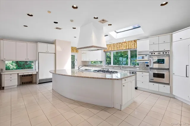 a kitchen with stainless steel appliances a stove a sink and a refrigerator