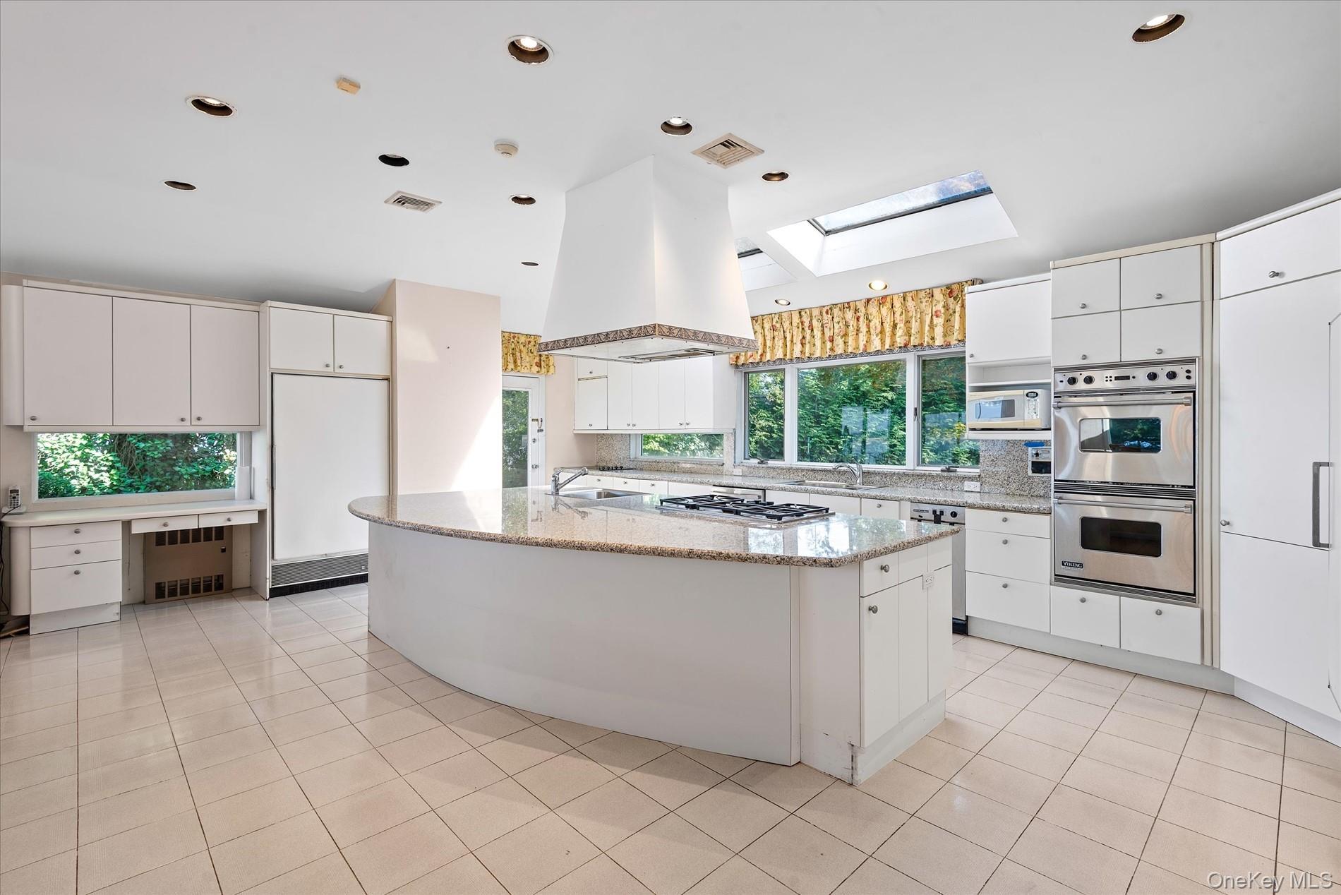 512 East Shore Road Great Neck, NY 11024 - Photo 20 of 46 a kitchen with stainless steel appliances a stove a sink and a refrigerator