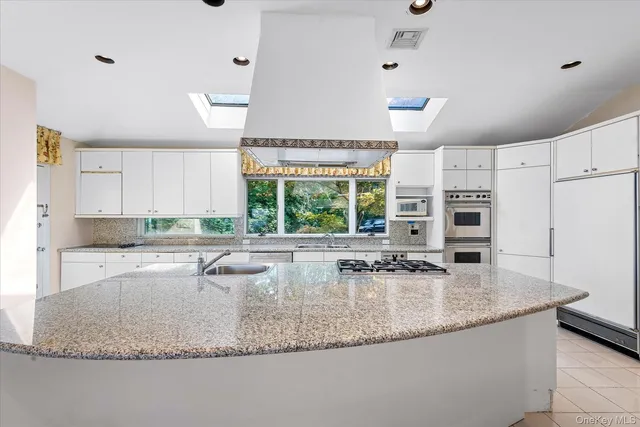 a kitchen with granite countertop a sink and a counter top space