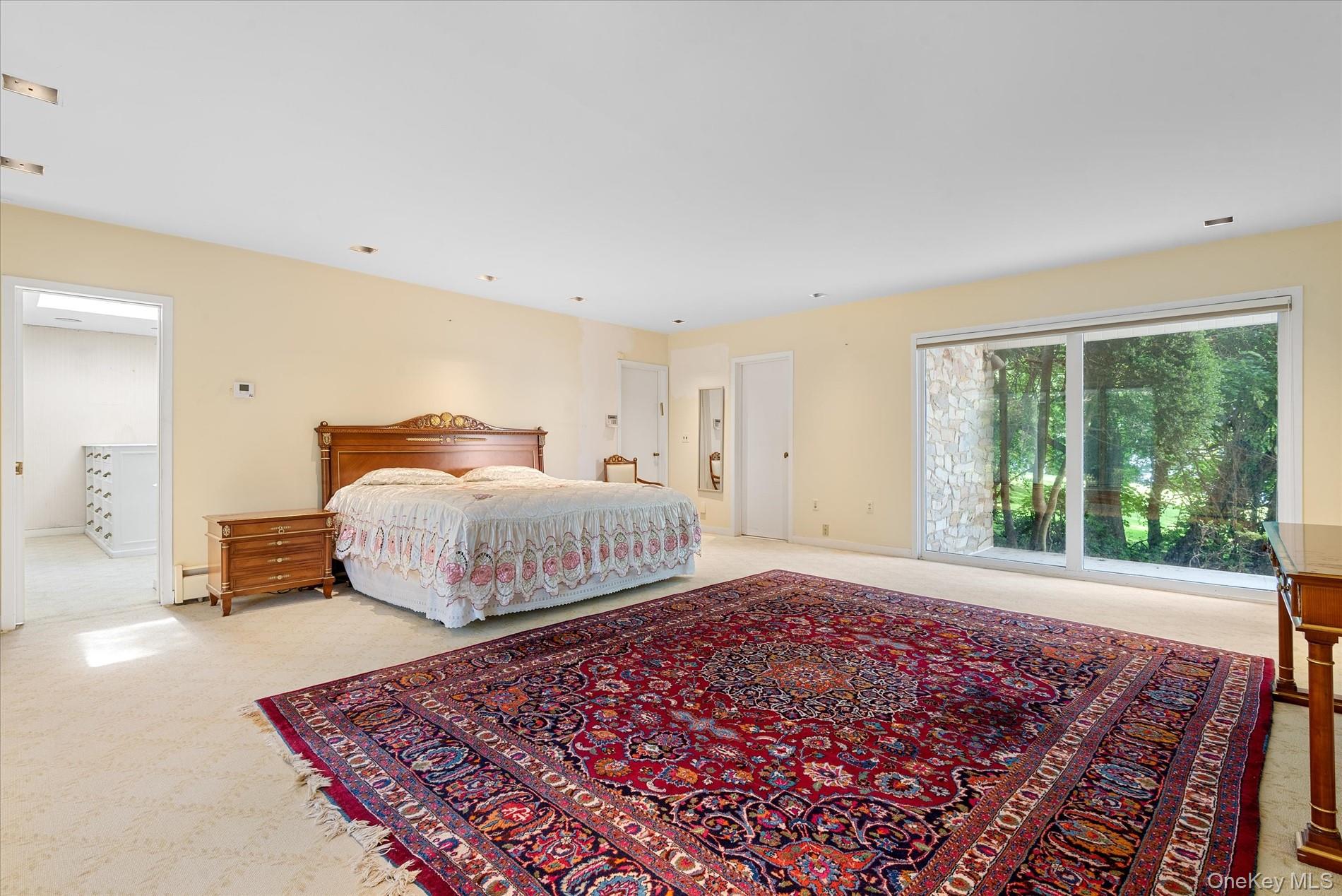 512 East Shore Road Great Neck, NY 11024 - Photo 27 of 46 a bedroom with a bed and wooden floor