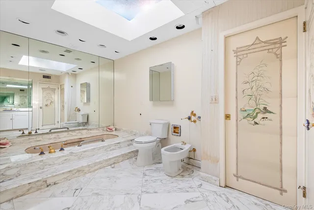 a bathroom with a granite countertop sink mirror and double