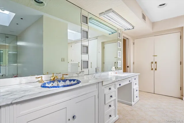 a spacious bedroom with a bed and a cabinets