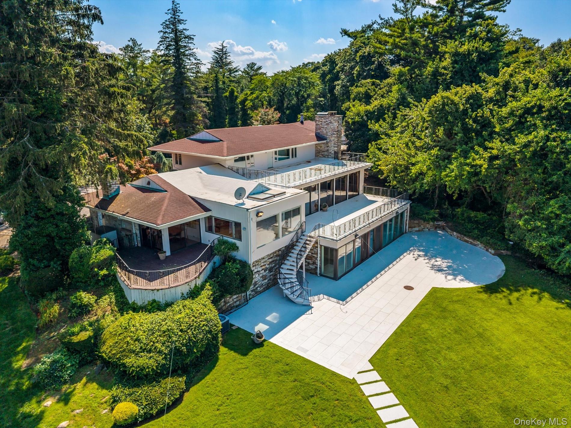 512 East Shore Road Great Neck, NY 11024 - Photo 38 of 46 an aerial view of a house with swimming pool and garden
