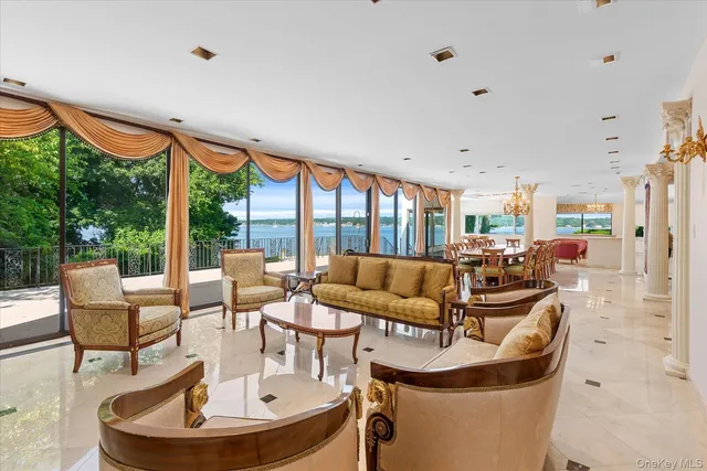a living room with fireplace furniture and a large window