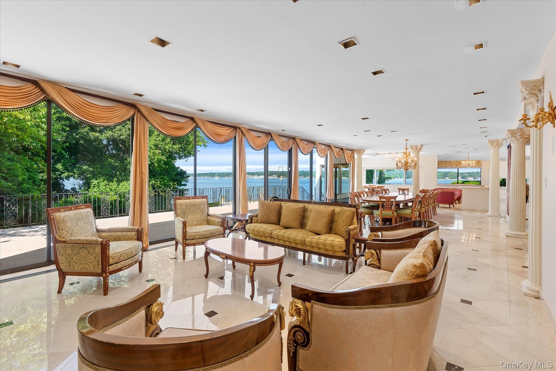 512 East Shore Road Great Neck, NY 11024 - Photo 10 of 46 a living room with fireplace furniture and a large window