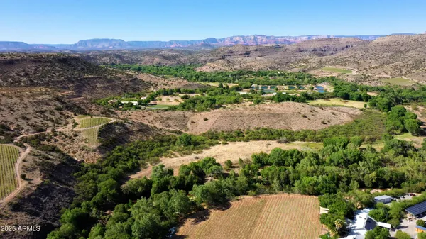 an aerial view of mountain with residential house and green space