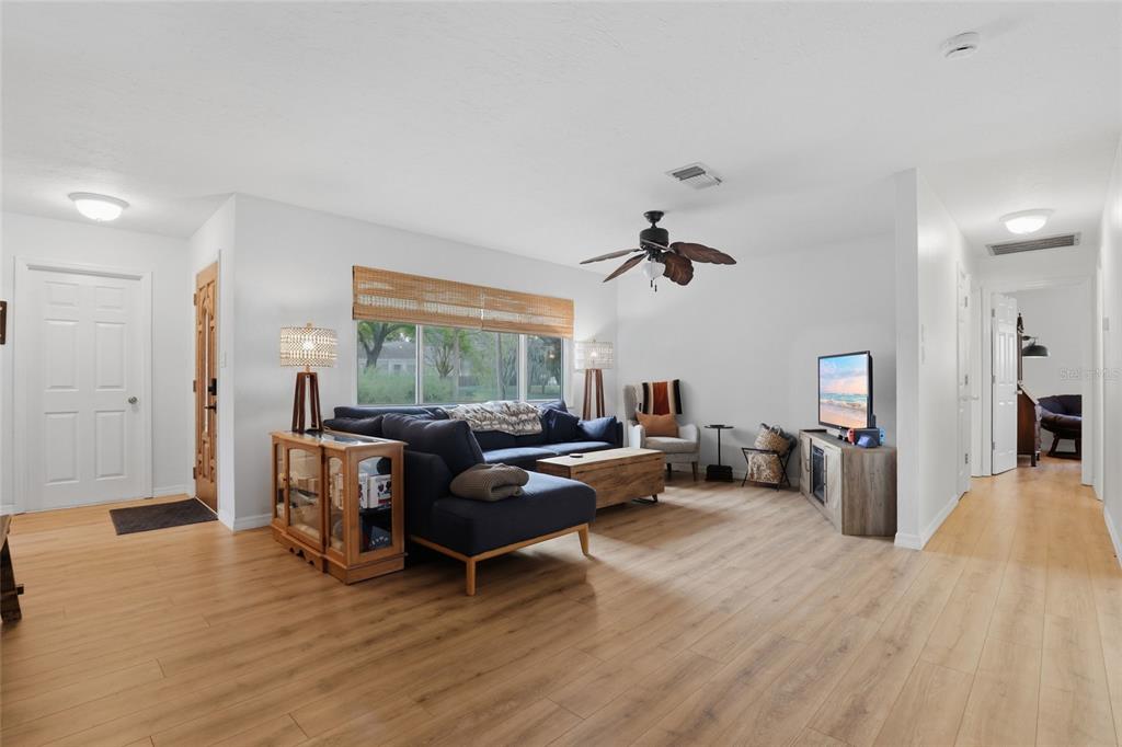 4576 Bliss Road Sarasota, FL 34233 - Photo 6 of 40 a living room with furniture and a wooden floor