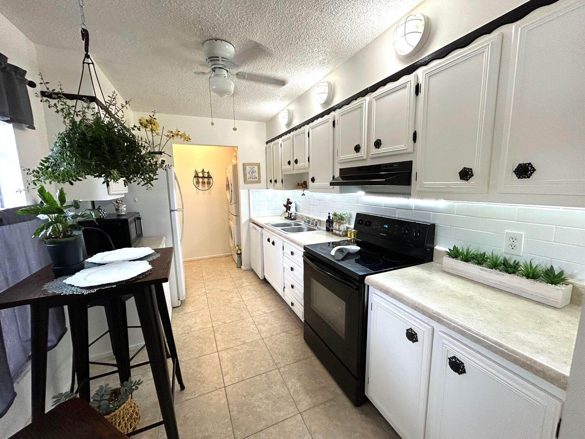 255 Down E Lane, Unit B Lake Worth, FL 33467 - Photo 2 of 31 a kitchen with stainless steel appliances granite countertop a stove a sink and a refrigerator