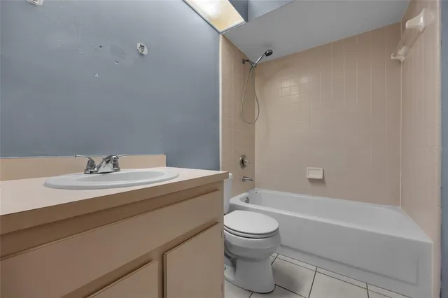 a bathroom with a granite countertop sink toilet a mirror and shower