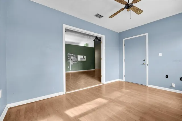 a view of a room with a ceiling fan