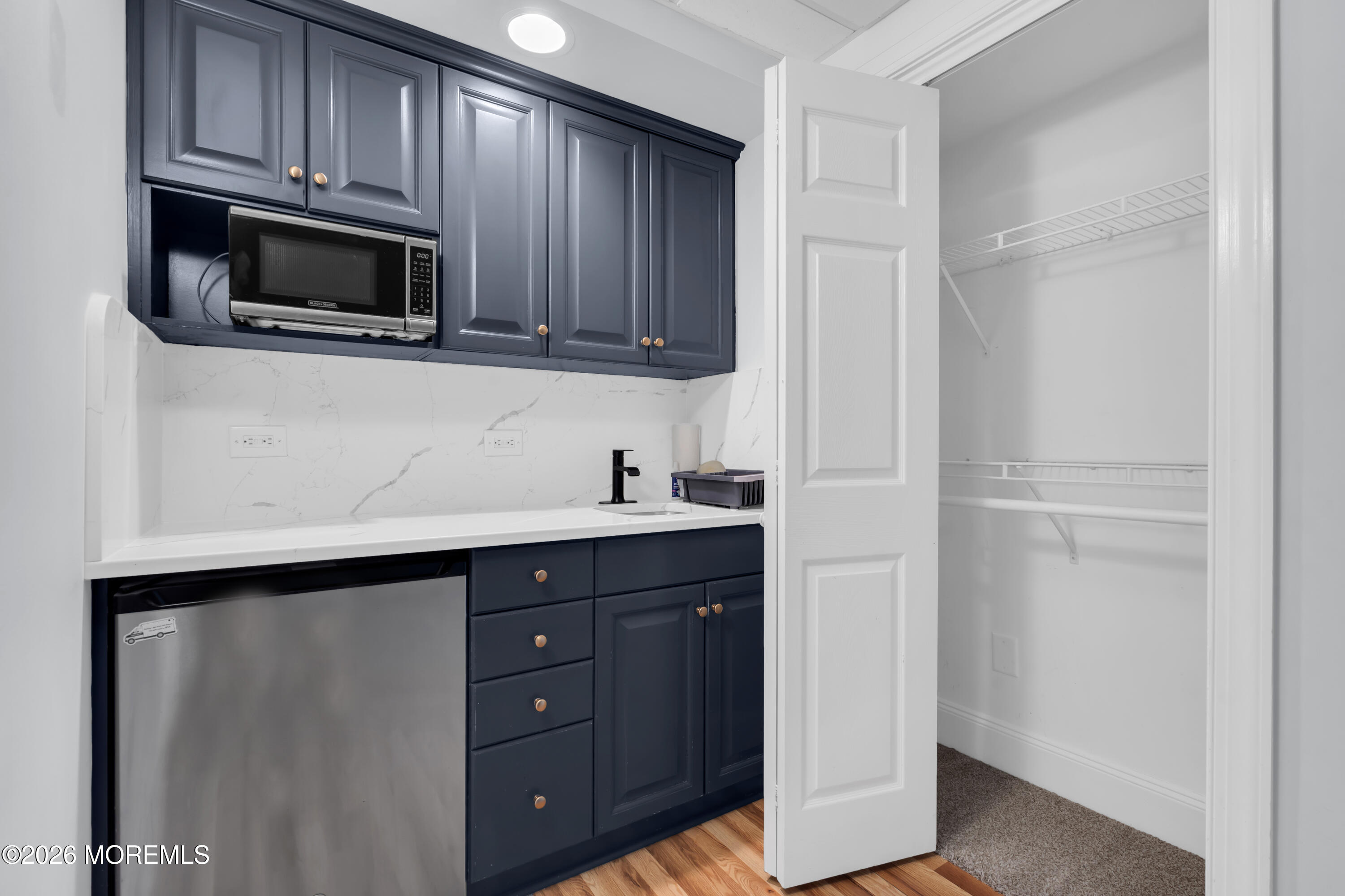 700 Ocean Avenue, Unit G29 Spring Lake, NJ 07762 - Photo 12 of 25 a kitchen with stainless steel appliances granite countertop a refrigerator and a microwave