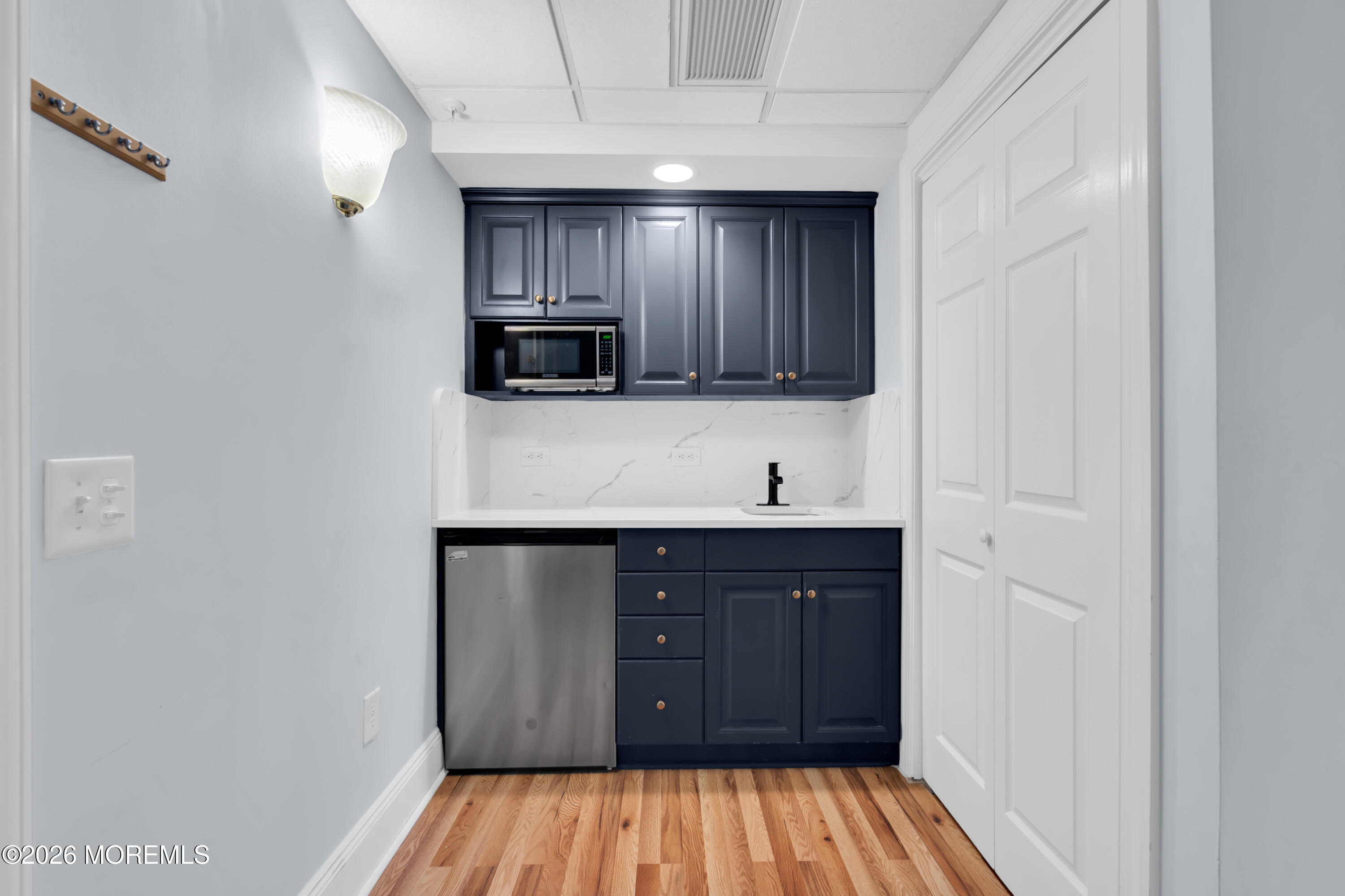700 Ocean Avenue, Unit G29 Spring Lake, NJ 07762 - Photo 13 of 25 a kitchen with wooden cabinets and a sink