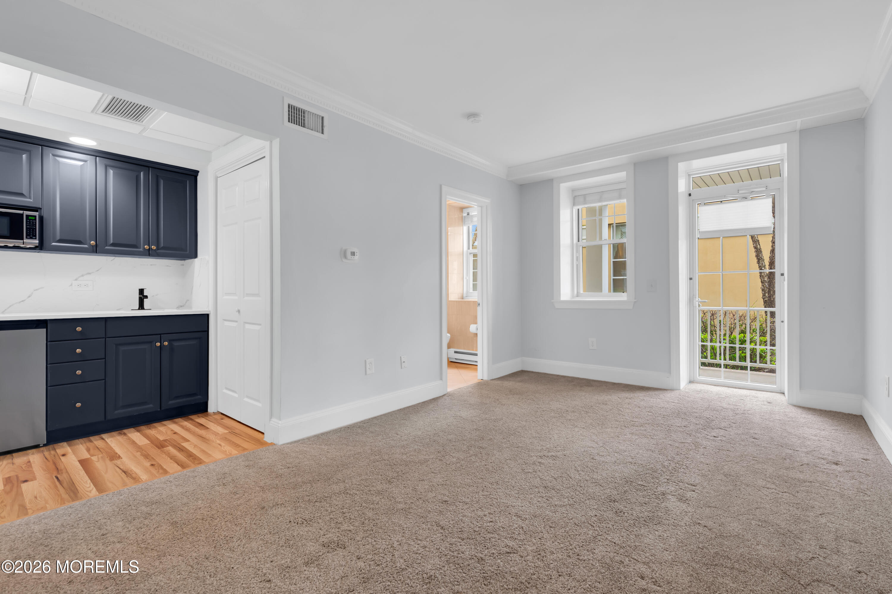 700 Ocean Avenue, Unit G29 Spring Lake, NJ 07762 - Photo 19 of 25 a view of an empty room with a window and a kitchen